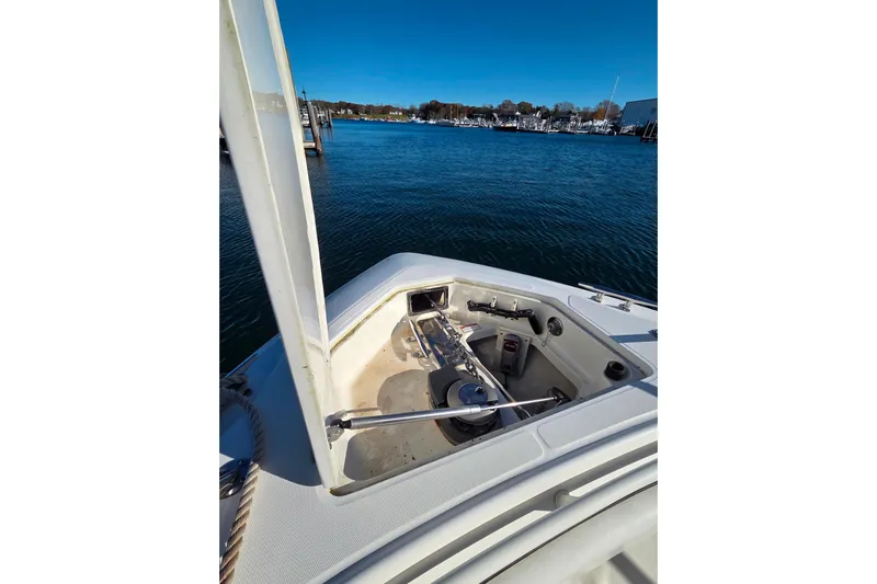  Yacht Photos Pics 2013 Boston Whaler 320 Outrage bow with anchor system, docked in a marina.