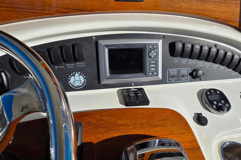  Yacht Photos Pics 2013 Boston Whaler 320 Outrage dashboard with controls and steering wheel.