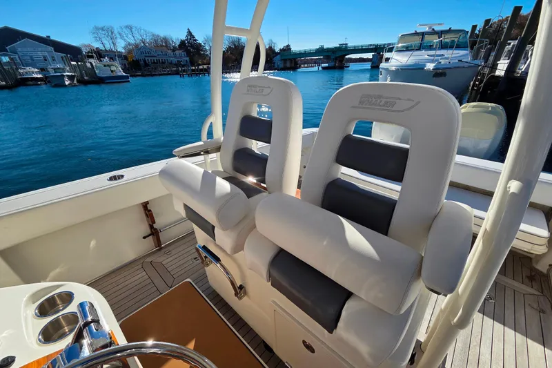  Yacht Photos Pics 2013 Boston Whaler 320 Outrage boat interior with comfortable seating and scenic waterfront view.