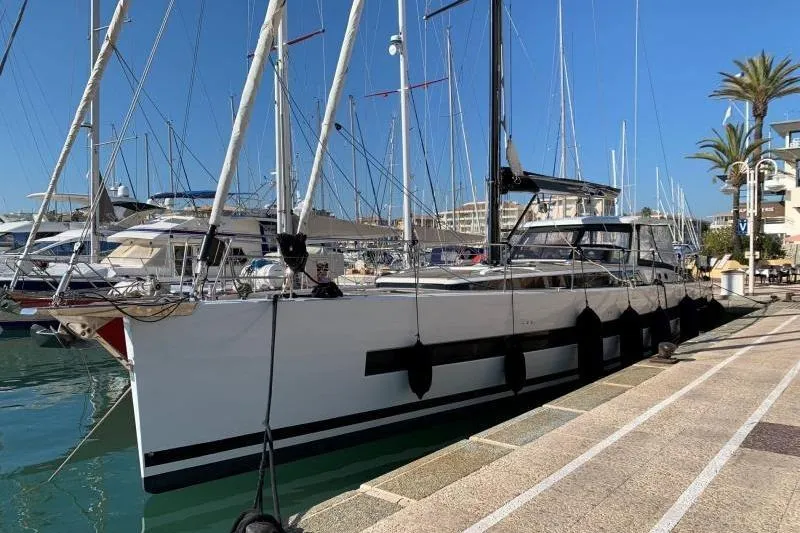 Petit Miracle 2 Yacht Photos Pics 2018 Beneteau Oceanis Yacht 62 docked at marina under clear blue sky.