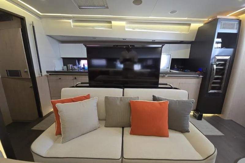 Petit Miracle 2 Yacht Photos Pics Luxurious interior of 2018 Beneteau Oceanis Yacht 62 with modern decor and comfortable seating.