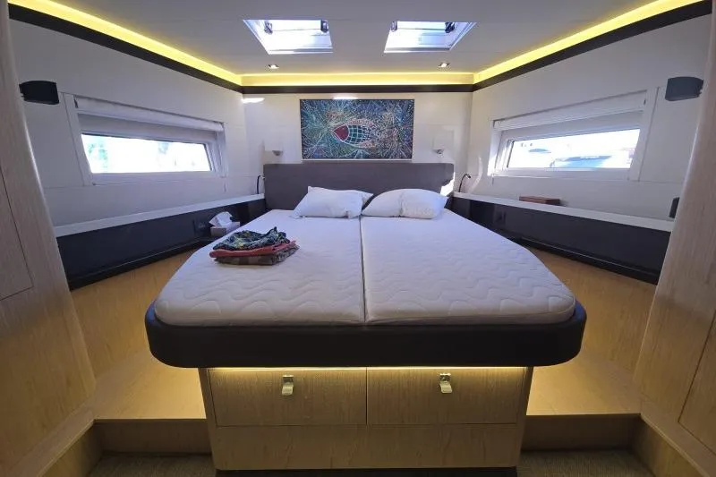 Petit Miracle 2 Yacht Photos Pics Luxurious bedroom interior of 2018 Beneteau Oceanis Yacht 62 with modern decor.