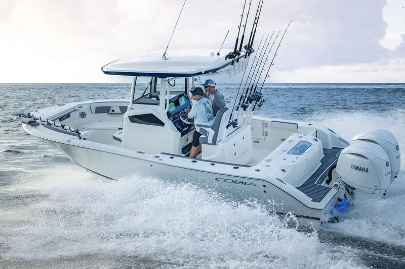 Yacht Photos Pics Manufacturer Provided Image: 2026 Cobia 245 Center Console boat cruising on ocean with fishing rods and Yamaha engines.