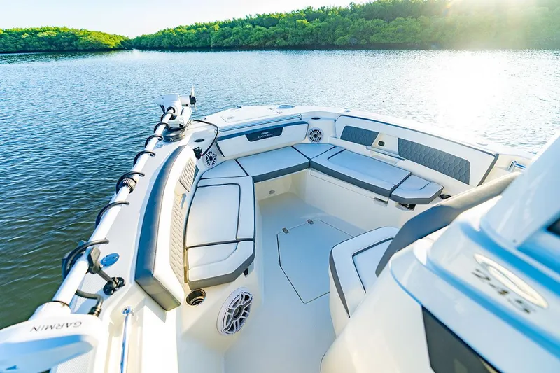 Yacht Photos Pics Manufacturer Provided Image: 2026 Cobia 245 Center Console boat interior on calm water, featuring spacious seating.