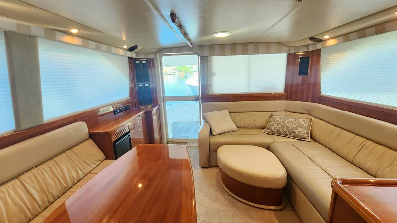 La Marce Yacht Photos Pics Luxurious interior of 2002 Riviera 40 Flybridge yacht with plush seating and elegant wood finishes.