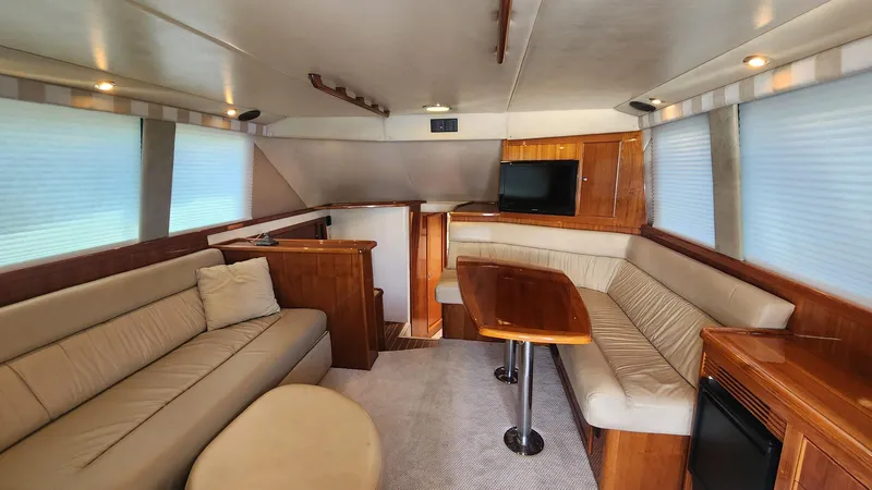 La Marce Yacht Photos Pics Luxurious interior of 2002 Riviera 40 Flybridge yacht with plush seating and wooden accents.