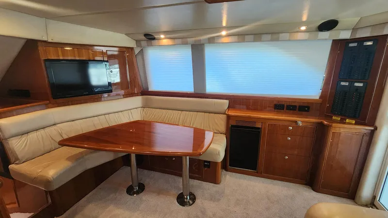 La Marce Yacht Photos Pics Luxurious interior of 2002 Riviera 40 Flybridge yacht with wood finish and seating area.