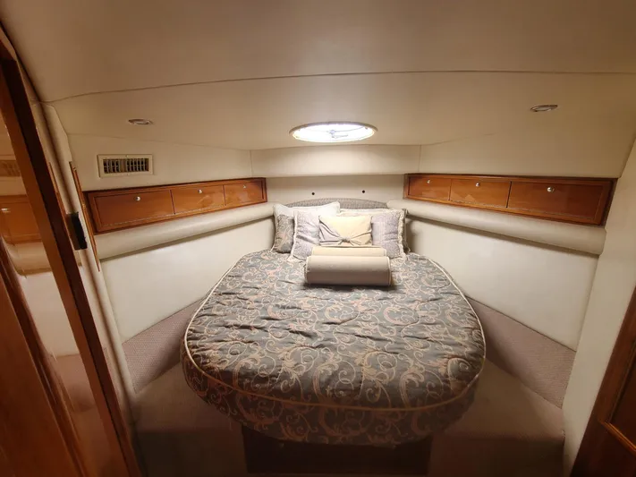 La Marce Yacht Photos Pics Luxurious bedroom interior of 2002 Riviera 40 Flybridge yacht with elegant bedding and wood accents.