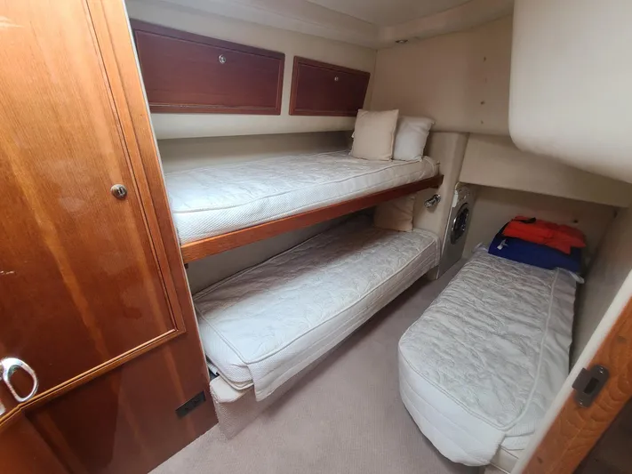 La Marce Yacht Photos Pics Interior cabin of 2002 Riviera 40 Flybridge with bunk beds and storage.
