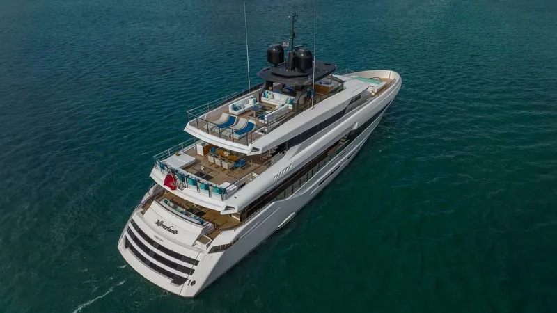 Neverland Yacht Photos Pics Luxurious 2016 Mangusta Oceano 42 yacht cruising on clear blue waters.