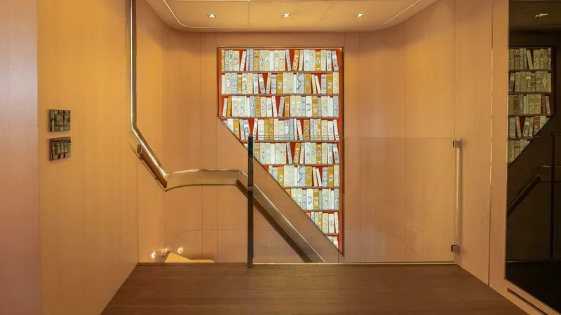 Neverland Yacht Photos Pics Luxurious interior of 2016 Mangusta Oceano 42 yacht with modern staircase and decorative wall.