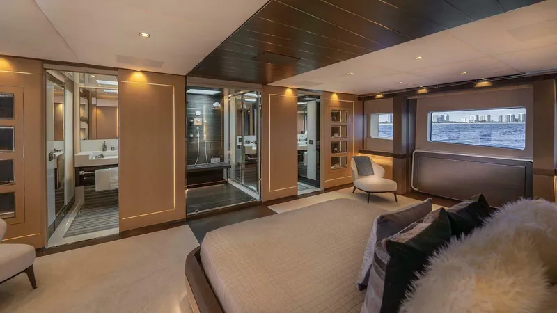 Neverland Yacht Photos Pics Luxurious interior of 2016 Mangusta Oceano 42 yacht with elegant bedroom and modern bathroom.