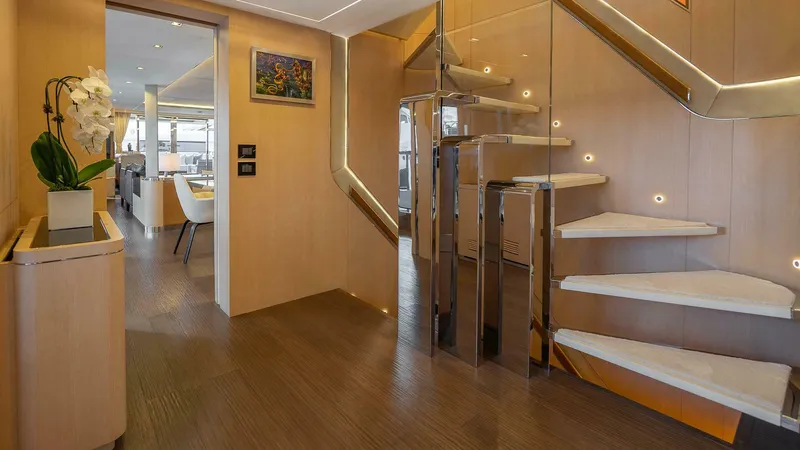 Neverland Yacht Photos Pics Luxurious interior of 2016 Mangusta Oceano 42 yacht with modern staircase and elegant decor.