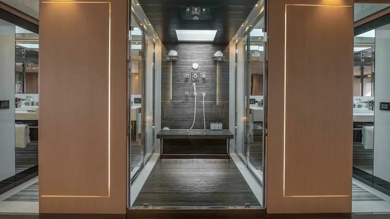 Neverland Yacht Photos Pics Luxurious shower area on 2016 Mangusta Oceano 42 yacht, featuring modern design and ambient lighting.