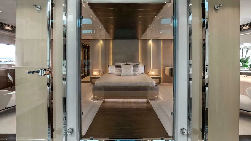 Neverland Yacht Photos Pics Luxurious bedroom interior of 2016 Mangusta Oceano 42 yacht, featuring modern design and elegant lighting.