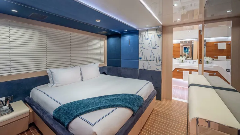 Neverland Yacht Photos Pics Luxurious bedroom interior on 2016 Mangusta Oceano 42 yacht, featuring elegant design and modern amenities.