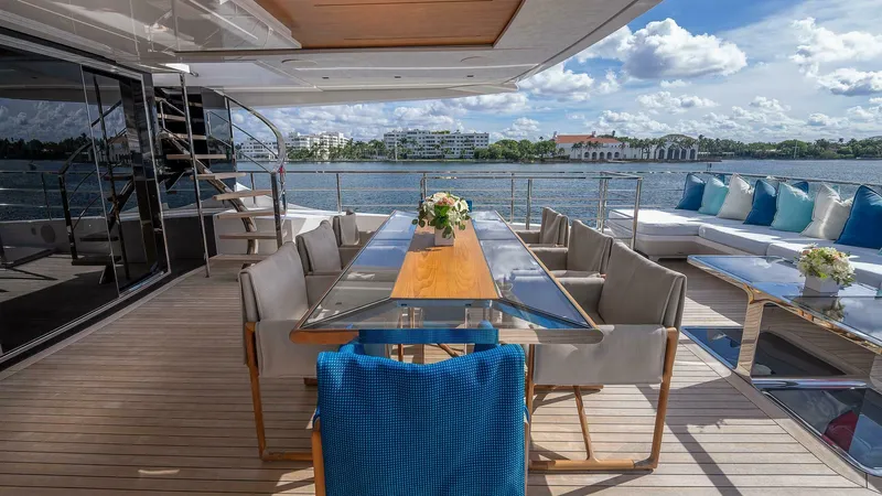 Neverland Yacht Photos Pics Luxurious deck of 2016 Mangusta Oceano 42 yacht with elegant dining area and scenic water view.