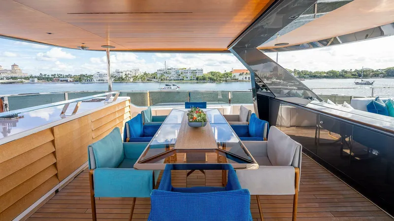 Neverland Yacht Photos Pics Luxurious outdoor dining area on 2016 Mangusta Oceano 42 yacht with waterfront view.