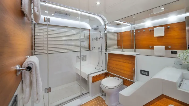 Neverland Yacht Photos Pics Luxurious bathroom on 2016 Mangusta Oceano 42 yacht with modern design and wooden accents.
