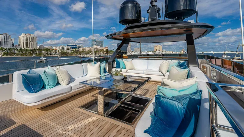 Neverland Yacht Photos Pics Luxurious deck of 2016 Mangusta Oceano 42 yacht with plush seating and scenic waterfront view.