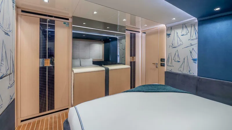 Neverland Yacht Photos Pics Luxurious bedroom interior of 2016 Mangusta Oceano 42 yacht with nautical-themed decor.