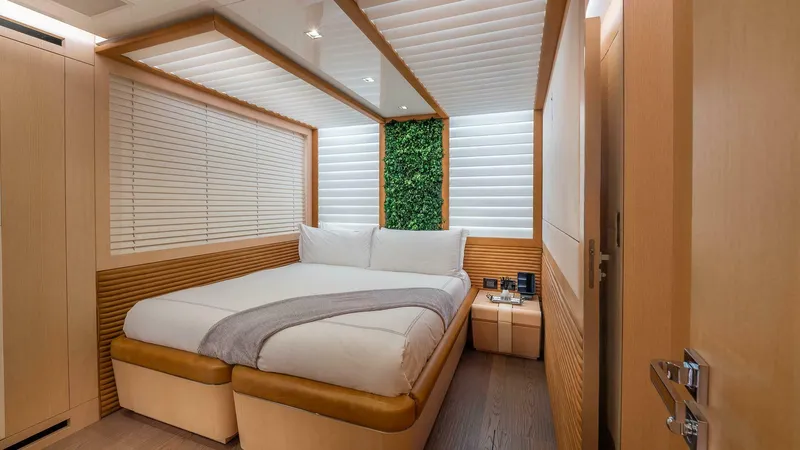 Neverland Yacht Photos Pics Luxurious bedroom interior on 2016 Mangusta Oceano 42 yacht, featuring modern design and cozy ambiance.