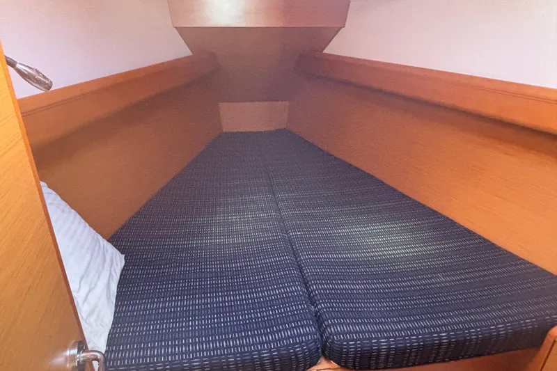 Eclipse Yacht Photos Pics Cozy cabin interior of 2018 Jeanneau Sun Odyssey 389 sailboat with comfortable bedding.