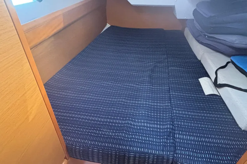 Eclipse Yacht Photos Pics Cabin interior of 2018 Jeanneau Sun Odyssey 389 with blue-striped bedding.