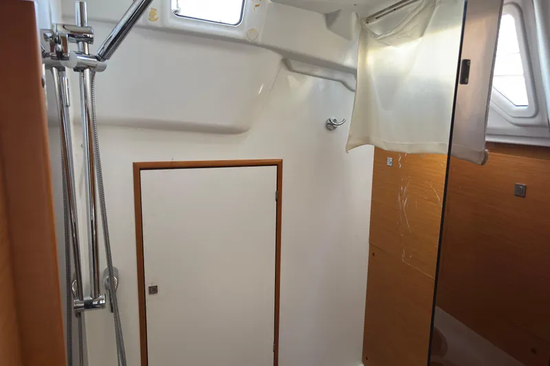 Eclipse Yacht Photos Pics Interior of 2018 Jeanneau Sun Odyssey 389 yacht bathroom with shower and wooden accents.