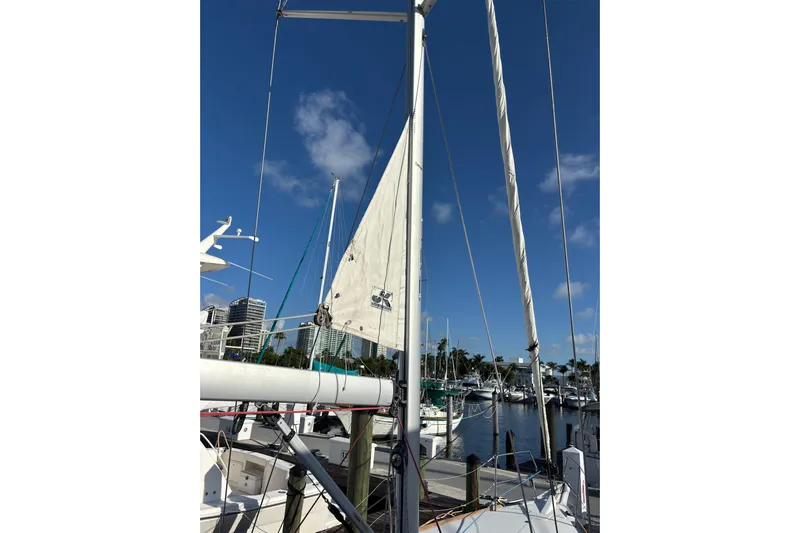 Eclipse Yacht Photos Pics 2018 Jeanneau Sun Odyssey 389 sailboat docked at marina under clear blue sky.