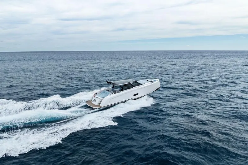 Shir Yacht Photos Pics 2024 Vanquish VQ58 yacht cruising on open sea under cloudy sky.