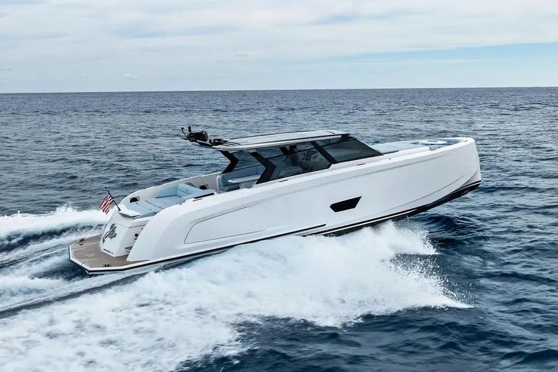 Shir Yacht Photos Pics 2024 Vanquish VQ58 yacht cruising on open sea, showcasing sleek design and luxury.