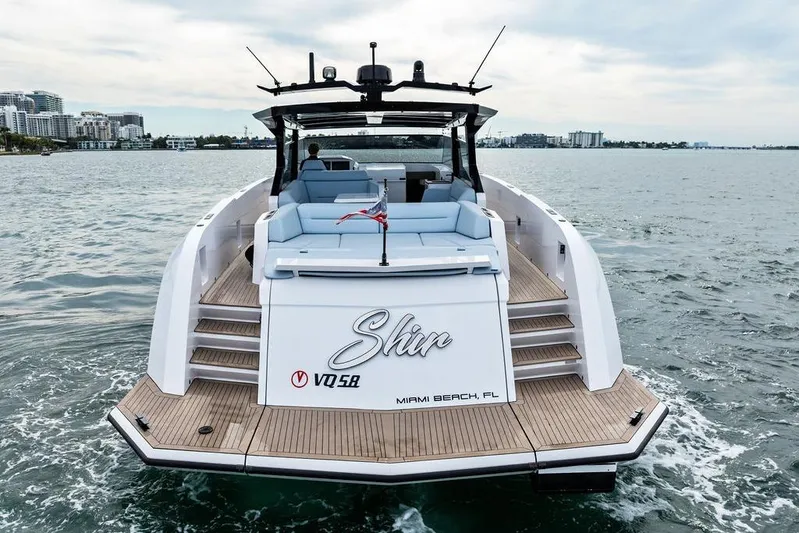 Shir Yacht Photos Pics 2024 Vanquish VQ58 luxury yacht cruising near Miami Beach, featuring sleek design and spacious deck.
