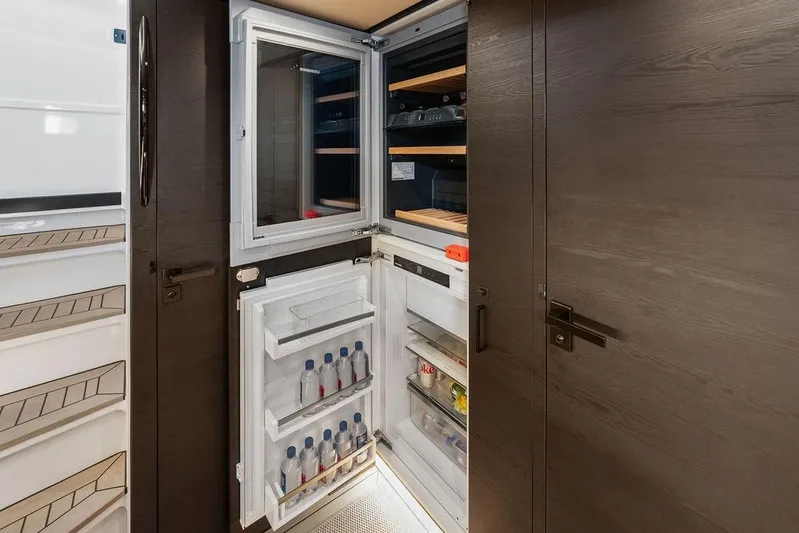 Shir Yacht Photos Pics 2024 Vanquish VQ58 yacht interior with open refrigerator, showcasing modern design and ample storage.