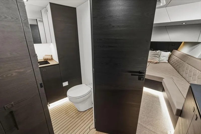 Shir Yacht Photos Pics Luxurious interior of 2024 Vanquish VQ58 yacht featuring modern bathroom and cozy seating area.