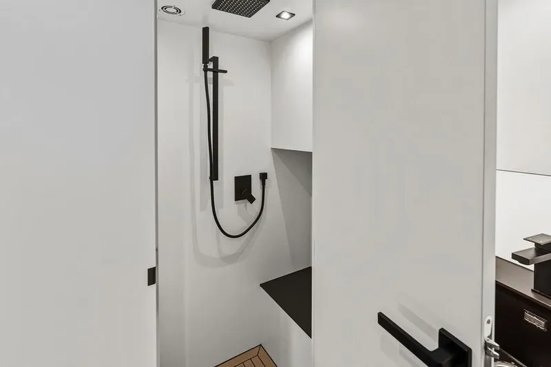 Shir Yacht Photos Pics Modern shower area in 2024 Vanquish VQ58 yacht, featuring sleek black fixtures.