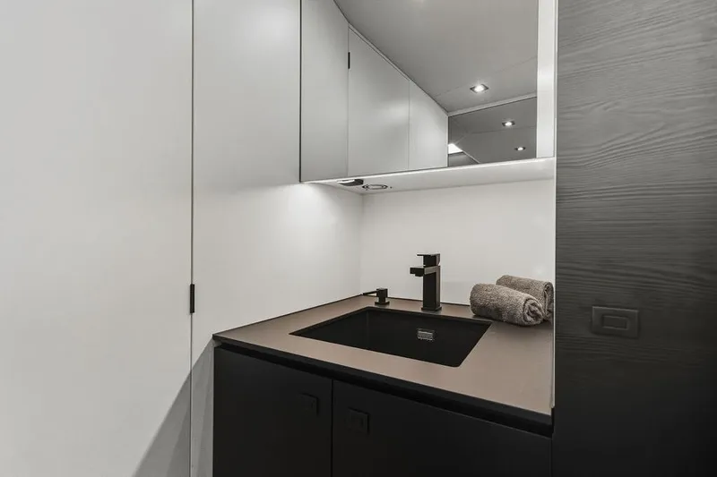 Shir Yacht Photos Pics Modern bathroom sink area in 2024 Vanquish VQ58 yacht, featuring sleek design and lighting.