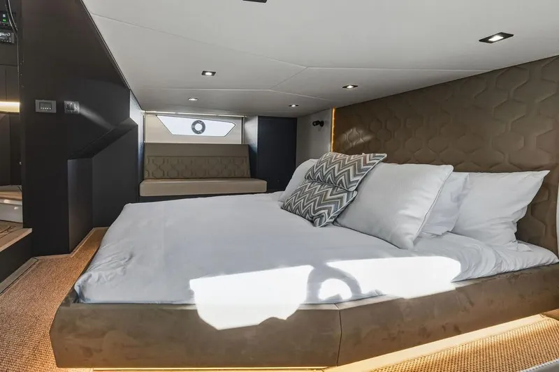 Shir Yacht Photos Pics Luxurious interior cabin of 2024 Vanquish VQ58 yacht with modern bedding and seating.