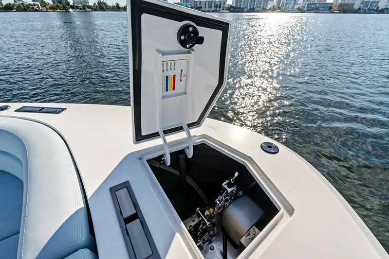 Shir Yacht Photos Pics Open hatch on 2024 Vanquish VQ58 yacht, revealing mechanical components, with water view.
