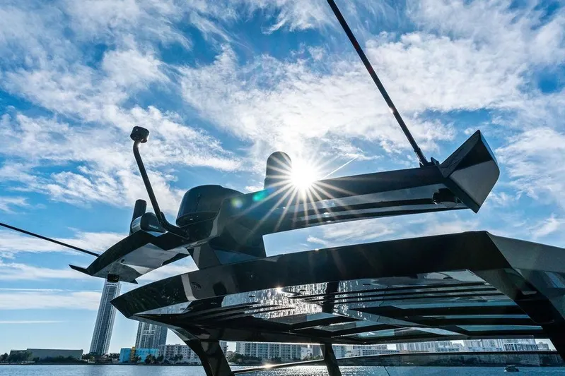 Shir Yacht Photos Pics 2024 Vanquish VQ58 yacht with sunburst and city skyline background.