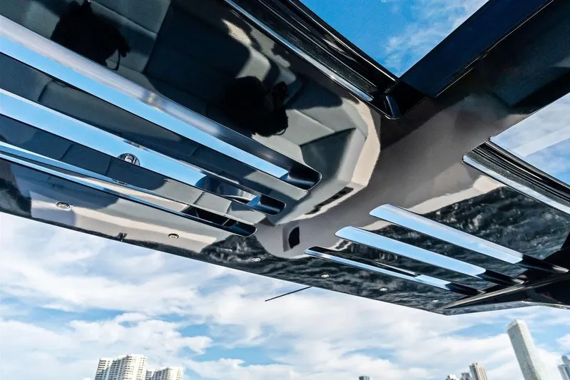 Shir Yacht Photos Pics 2024 Vanquish VQ58 yacht roof detail with city skyline and blue sky background.