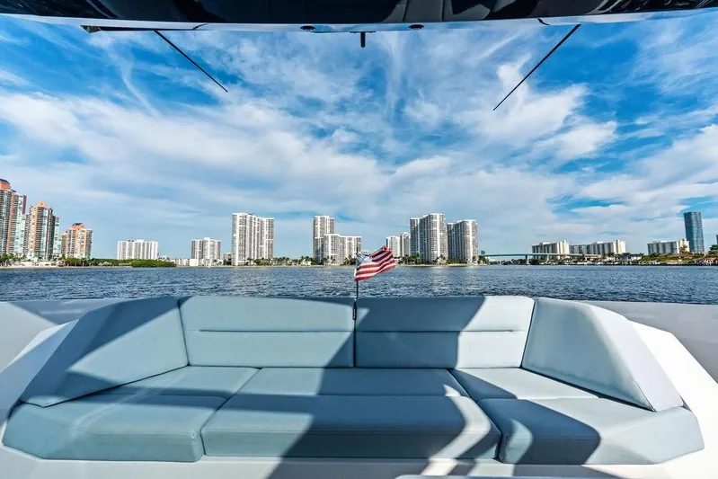 Shir Yacht Photos Pics 2024 Vanquish VQ58 yacht with city skyline and American flag in the background.