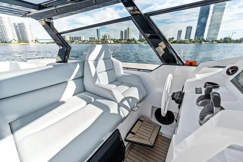 Shir Yacht Photos Pics Luxurious interior of 2024 Vanquish VQ58 yacht with modern helm and panoramic windows.