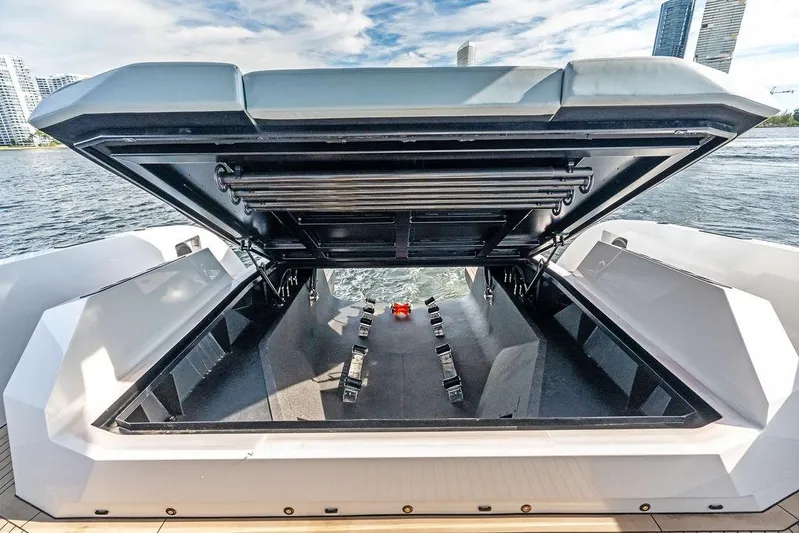 Shir Yacht Photos Pics 2024 Vanquish VQ58 yacht with open storage compartment, city skyline in background.