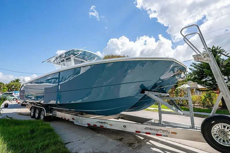  Yacht Photos Pics 2025 Invincible 38 Catamaran on trailer under blue sky.