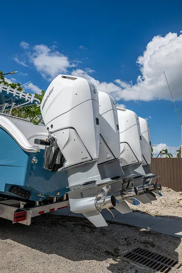  Yacht Photos Pics 2025 Invincible 38 Catamaran with triple outboard engines under a clear blue sky.