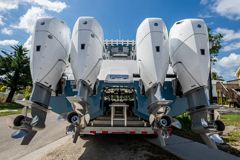  Yacht Photos Pics 2025 Invincible 38 Catamaran with four powerful outboard engines, parked on a trailer.
