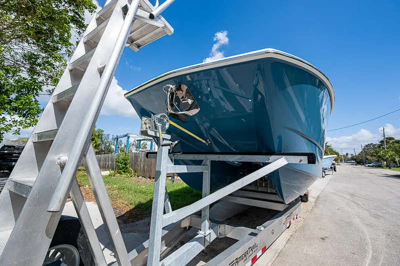  Yacht Photos Pics 2025 Invincible 38 Catamaran on trailer under clear blue sky.