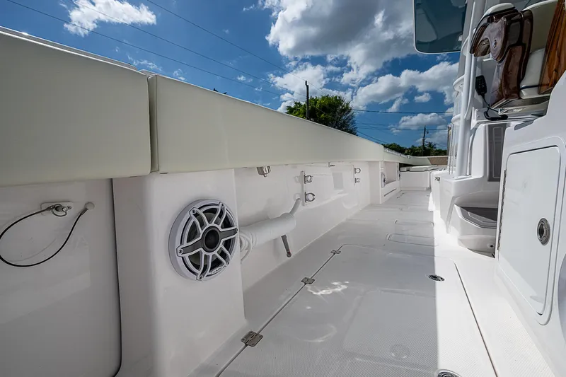  Yacht Photos Pics 2025 Invincible 38 Catamaran deck with speaker, under a bright blue sky.