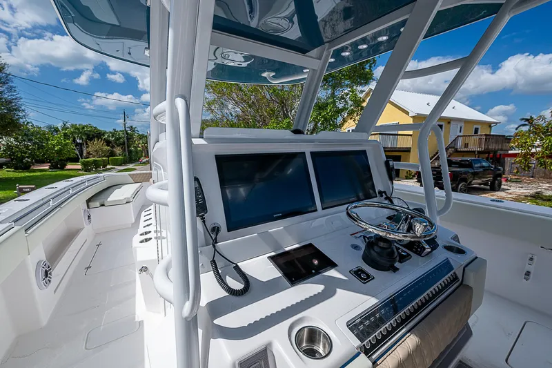  Yacht Photos Pics 2025 Invincible 38 Catamaran cockpit with dual screens and steering wheel.